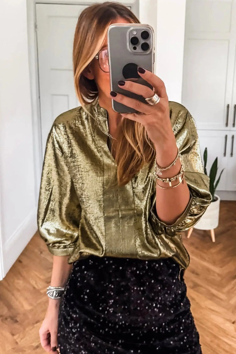 Gold metallic blouse showing split neckline and half sleeve detail under studio lighting Fashionfitz UK