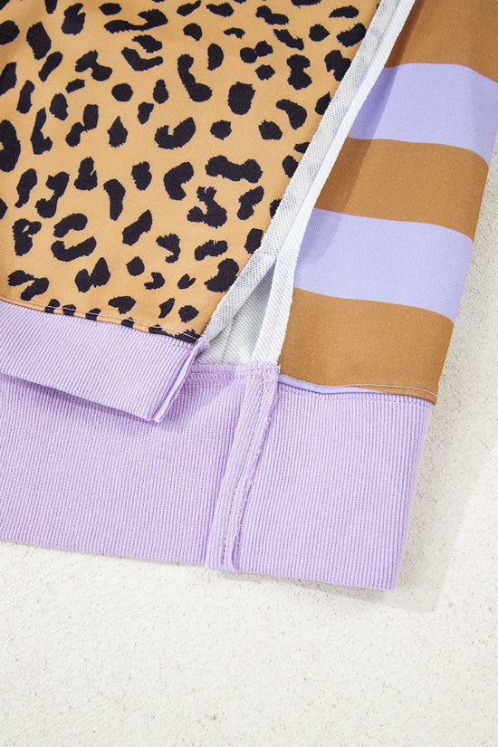 Detail of side slit and stitching on lavender Curve Leopard Stripe Baggy Sweatshirt, emphasizing quality design and comfortable fit.