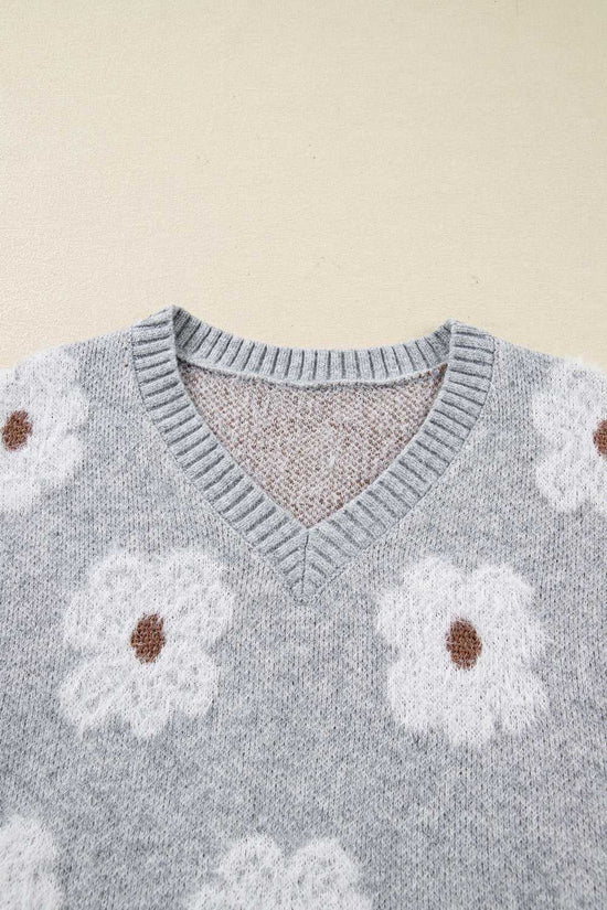 Close-up of V-neckline on FashionFitz Oversized Grey Floral Knit Jumper with ribbed trim and fluffy white floral print.