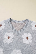 Close-up of V-neckline on FashionFitz Oversized Grey Floral Knit Jumper with ribbed trim and fluffy white floral print.