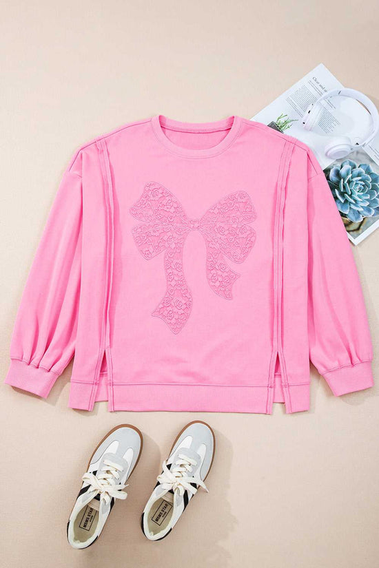 Flat lay of Pink Bow Plus Size Sweatshirt with lace detail, styled with sneakers. A cute and comfy pullover for everyday wear.