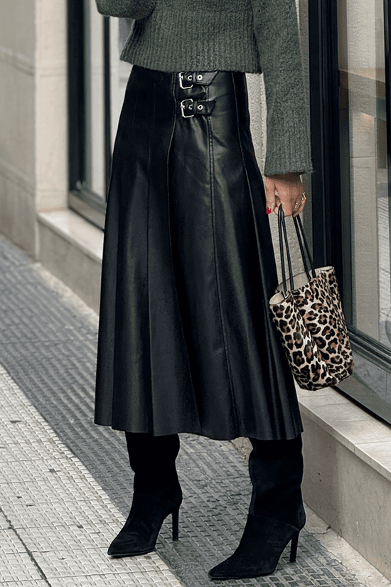 Black Faux Leather Pleated Flared Skirt | FashionFitz styled with heeled boots and animal print bag, ideal for modern fall fashion.