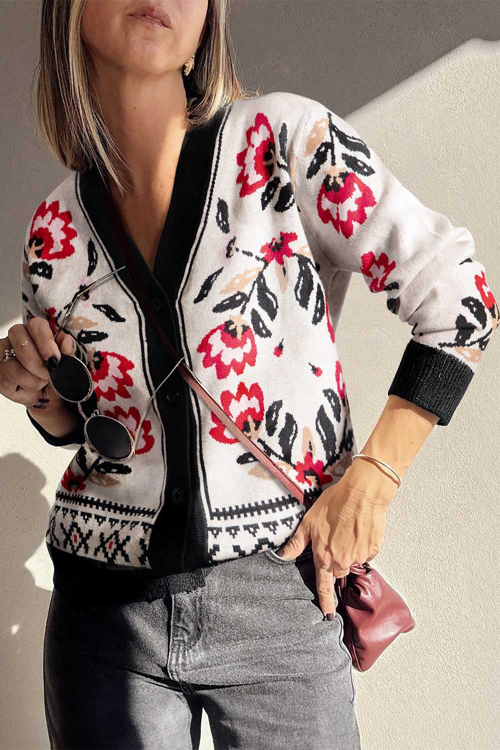 Model wearing beige floral button-up knit cardigan with V-neck and long sleeves