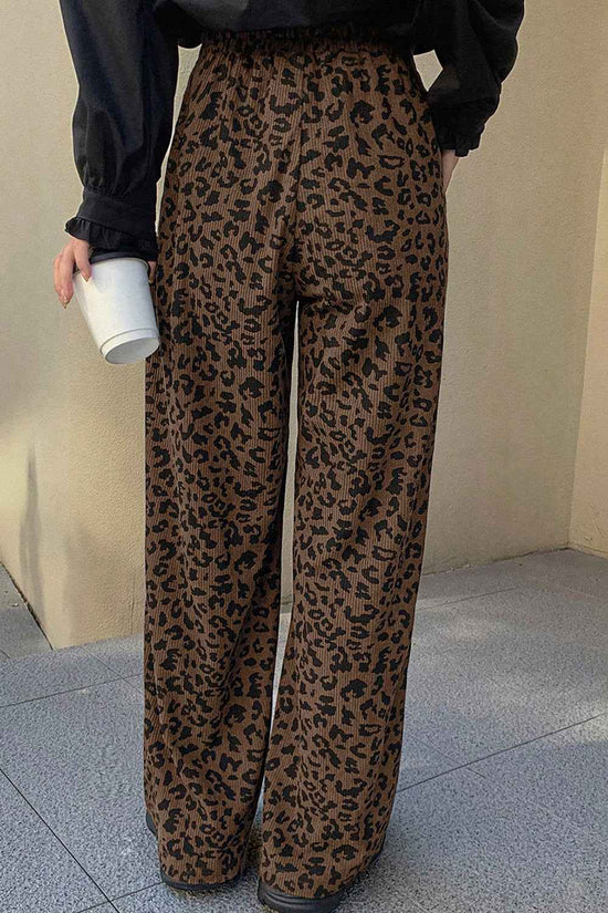 Back view of brown leopard print corduroy trousers women, showcasing elastic waistband and wide leg cut for comfort and style.