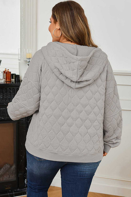 Back view of women's curve grey quilted quarter-zip hoodie showing hood and diamond quilted pattern, ideal for plus size winter fashion.