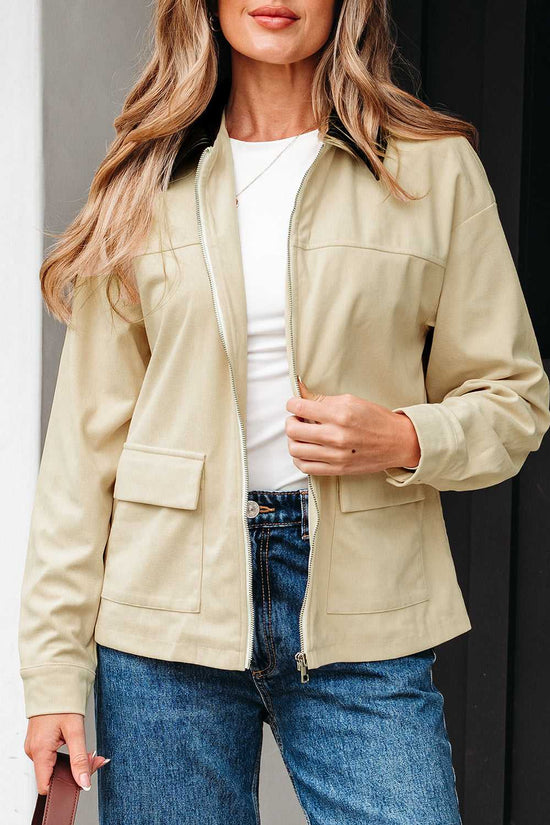 Model unzipping Leather Collar Corduroy Jacket, styled with white top and jeans, ideal for fall layering.