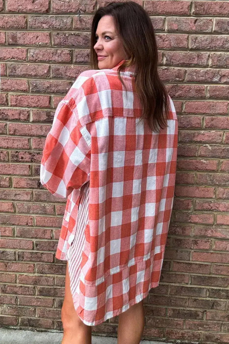 Close-up of pink plaid shirt dress collar and button details