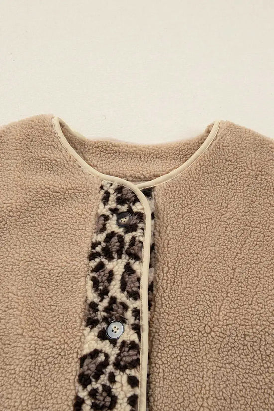 Close-up of neckline and button placket on women’s plush leopard print jacket, featuring sherpa fleece and contrast trim.