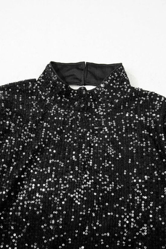 Detail of high neckline and back button closure on black sequin bell sleeve blouse, ideal for festive and elegant styling.