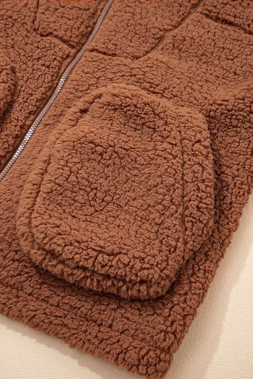 Close-up of front pocket on Women's Zip‑Up Sherpa Hoodie Jacket, showcasing textured sherpa fabric and casual design.