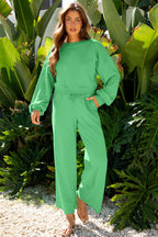 Green Drop Crop Wide-Leg Pants Set modeled in tropical setting, highlighting relaxed fit and drawstring waist for daily casual wear.