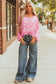 Full body view of model in Pink Floral Lightweight Blouse and wide-leg jeans, styled for a trendy spring look.
