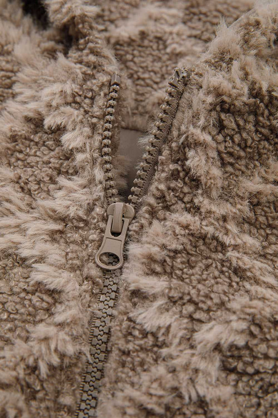 Close-up of zipper detail on Camel Sherpa Fleece Jacket showing durable zip and plush fleece texture, perfect for cold-weather outerwear.