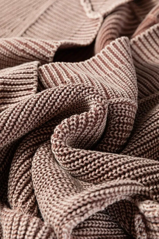 Textured fabric detail of brown stonewash patchwork knit open cardigan, emphasizing soft and cozy knit material.