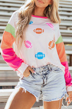 Close-up of Pink GAME DAY Graphic Top featuring bold football prints and soft cotton fabric, styled for casual autumn wear.