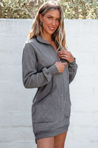 Model wearing gray zip-up sweatshirt dress with a casual fit and side pockets, perfect for daily wear in cooler seasons.