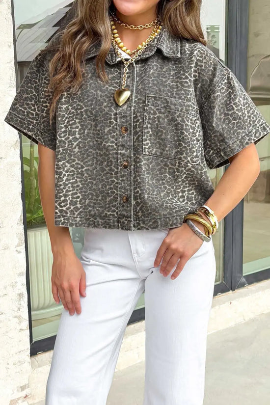 Front close-up of gray leopard denim shirt for women, showcasing button down design, chest pocket, and short sleeves.
