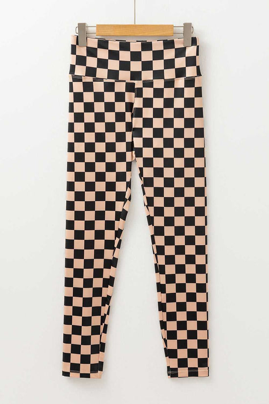 Flat lay of Checkered Skinny Leggings with high waist and tapered legs, showcasing their bold geometric print and sleek silhouette.