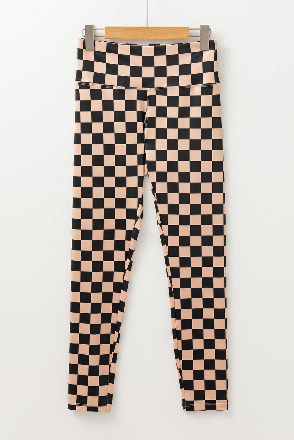Flat lay of Checkered Skinny Leggings with high waist and tapered legs, showcasing their bold geometric print and sleek silhouette.