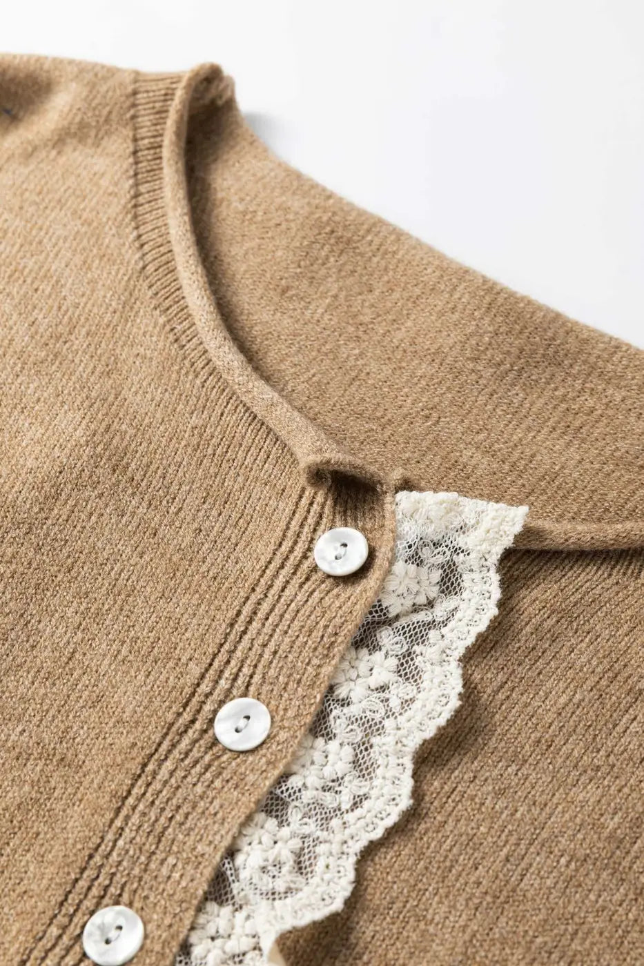 Close-up of Taupe Lace Trim Loose Cardigan showing white lace detail and ribbed button placket. Feminine and soft knitwear texture.