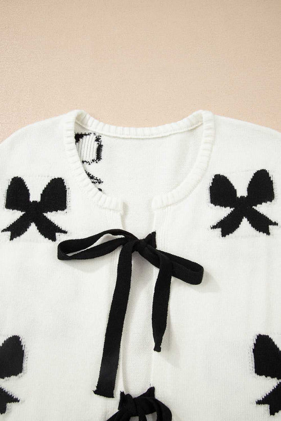 Close-up of neckline and bow details on White Bow‑Lace Knit Cardigan, showing soft knit fabric and delicate black ribbon accents.