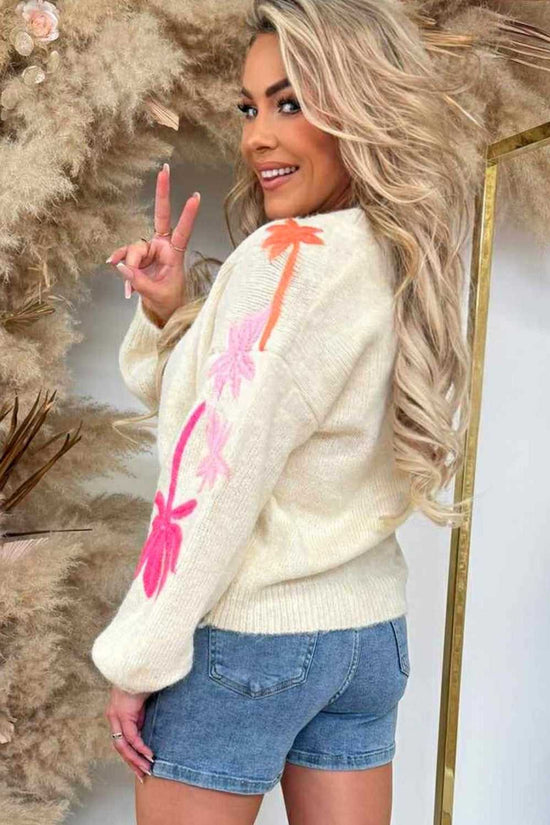 Back view of cream Floral Embroidered Sleeve Jumper for women, featuring bright floral embroidery and styled with denim shorts.