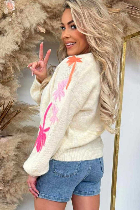 Back view of cream Floral Embroidered Sleeve Jumper for women, featuring bright floral embroidery and styled with denim shorts.