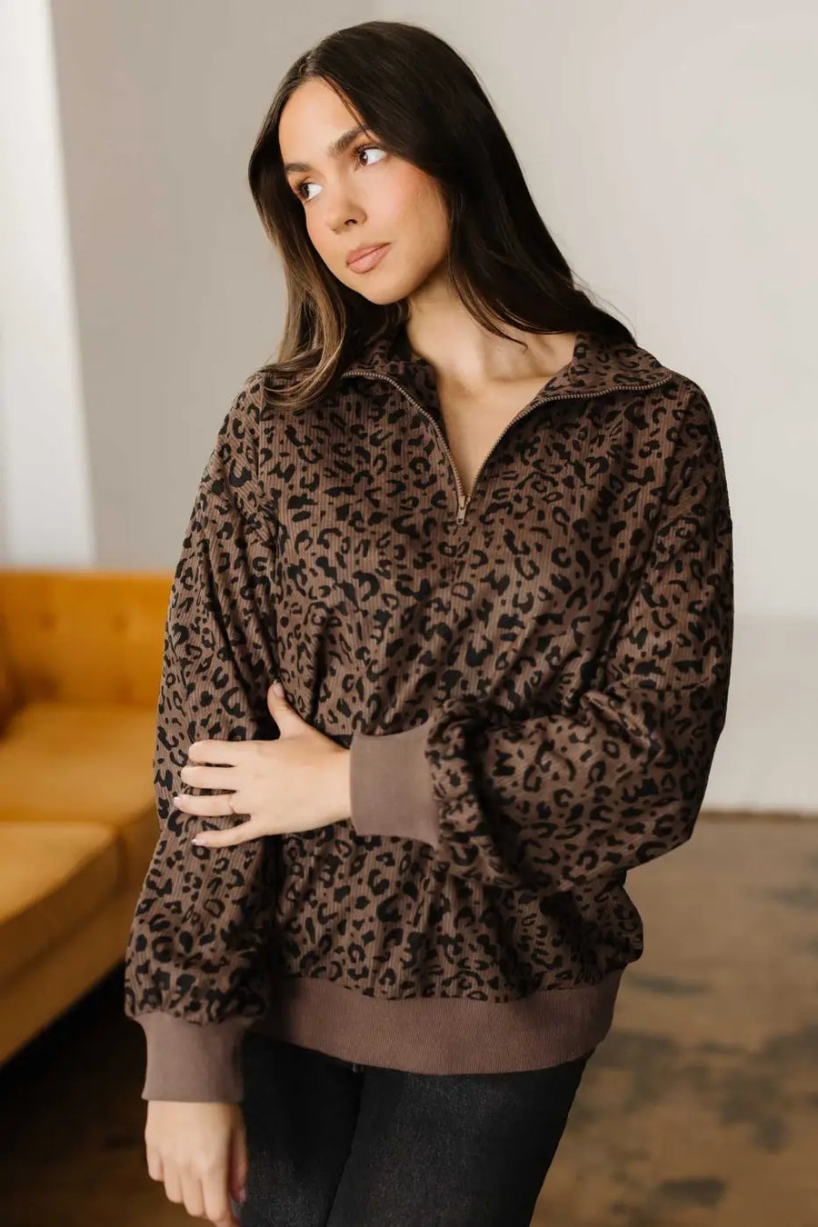 Model posing in Women's Brown Leopard Print Corduroy Half-Zip Jumper, showcasing its relaxed fit and bold animal print.