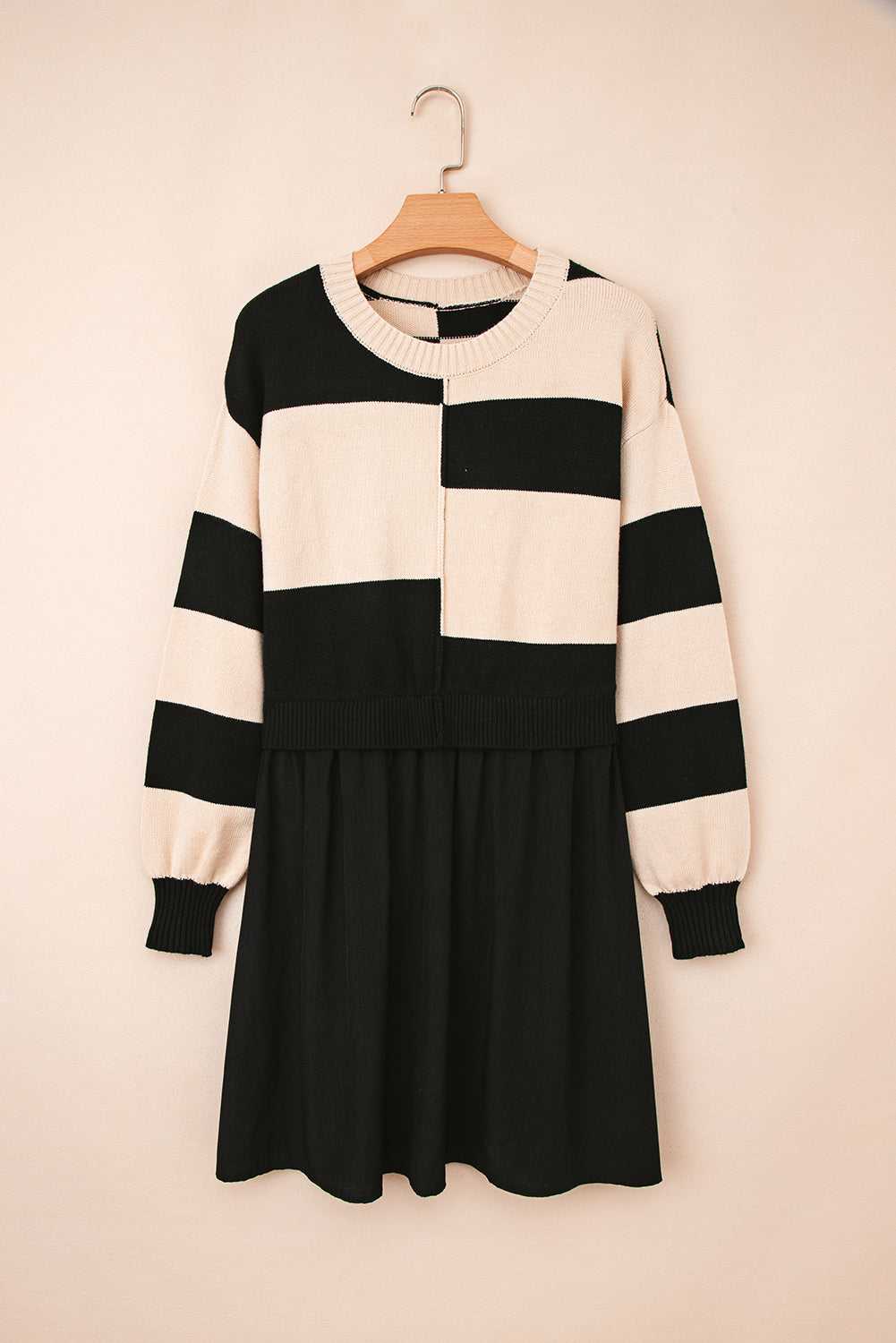Flat lay of Monochrome Knit Dress - Cozy & Stylish | FashionFitz on hanger, featuring bold horizontal stripes and gathered black skirt.
