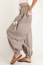 Side view of Brown Stripe Cargo Joggers for women, showcasing relaxed fit and tied cargo pockets.