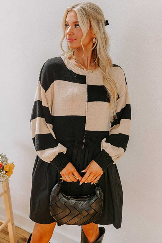 Model holding a black handbag wearing Monochrome Knit Dress - Cozy & Stylish | FashionFitz with striped knit top and pleated skirt silhouette.