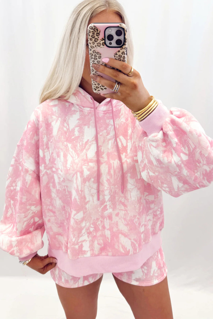 Abstract print hoodie and slim shorts set — styled with white trainers