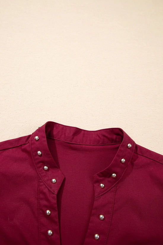V-neckline and rivet detail close-up on burgundy puff sleeve blouse | Fashionfitz