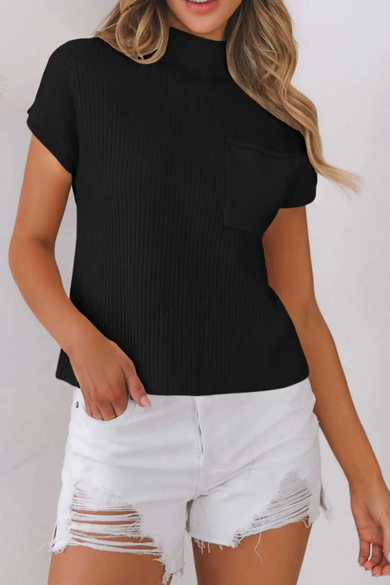 Woman in black ribbed knit short sleeve sweater paired with white distressed shorts, perfect for a stylish summer-to-fall transition.