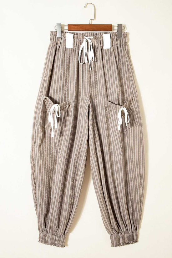 Flat lay of Women's Brown Stripe Cargo Joggers on hanger, highlighting drawstring waist and dual cargo pockets.