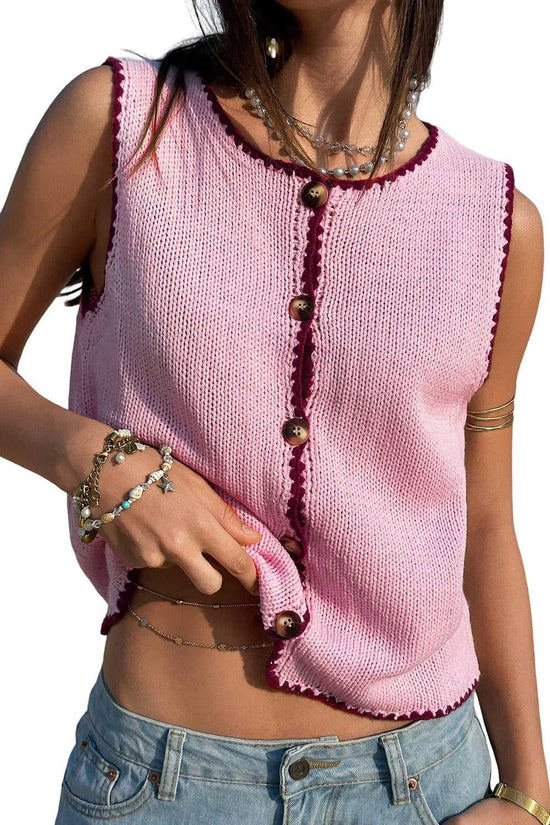 Isolated view of pink contrast trim knit crop top with sleeveless cut and wooden buttons, highlighting soft stretch fit and summer style.
