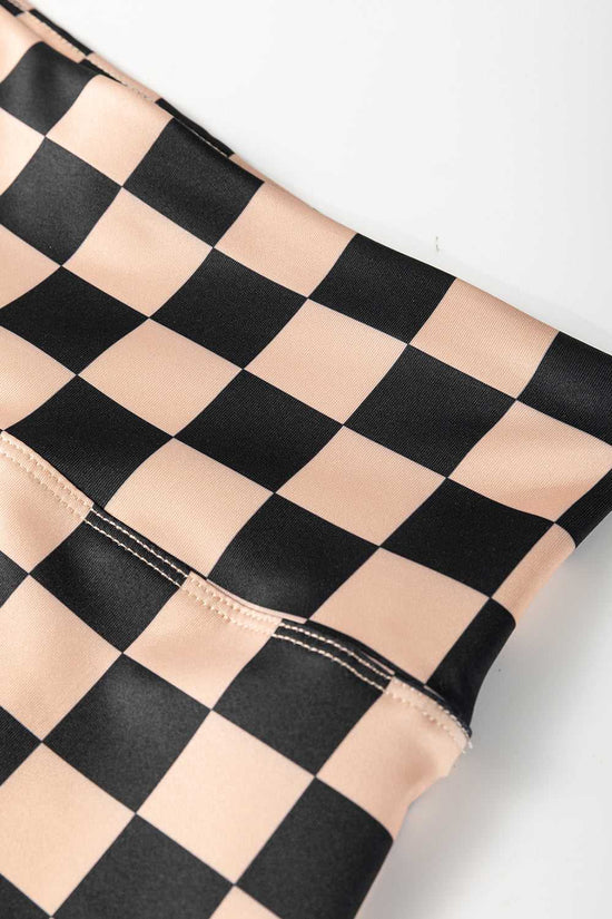 Close-up of waistband on Checkered Skinny Leggings, highlighting stitching detail and smooth, stretchy fabric for comfort and flexibility.