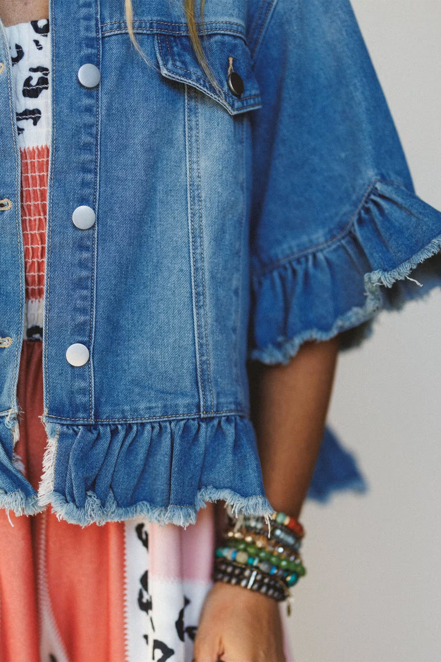 Ruffle hem denim jacket worn open over floral dress — Fashionfitz UK