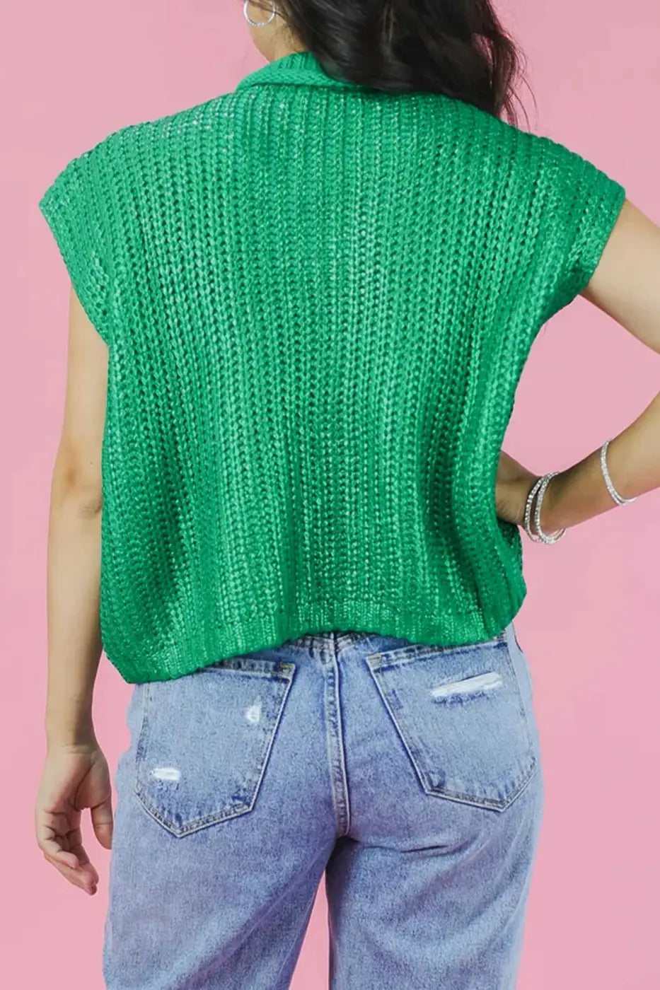 Green high neck knit top for women with short sleeves and lustre finish, styled with light blue ripped jeans. Loose fit ideal for summer wear.