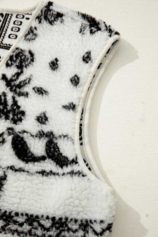 Armhole detail of the beige sherpa vest with black paisley print, emphasizing soft sherpa fabric and clean stitching.