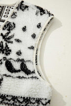 Armhole detail of the beige sherpa vest with black paisley print, emphasizing soft sherpa fabric and clean stitching.