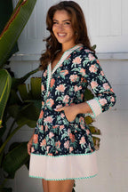 Side profile of the Ladies Blue Floral Shift Mini Dress with pockets, striped trim, and vibrant floral print, perfect for daily spring occasions.