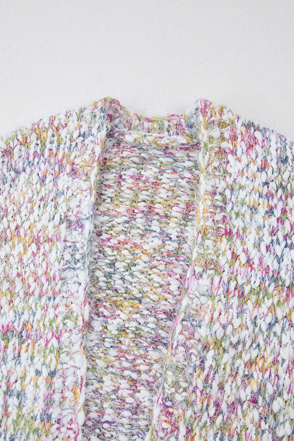 Close-up of white confetti knit cardigan for women, showcasing multicolor yarns in open front duster style. Ideal for fall layering.