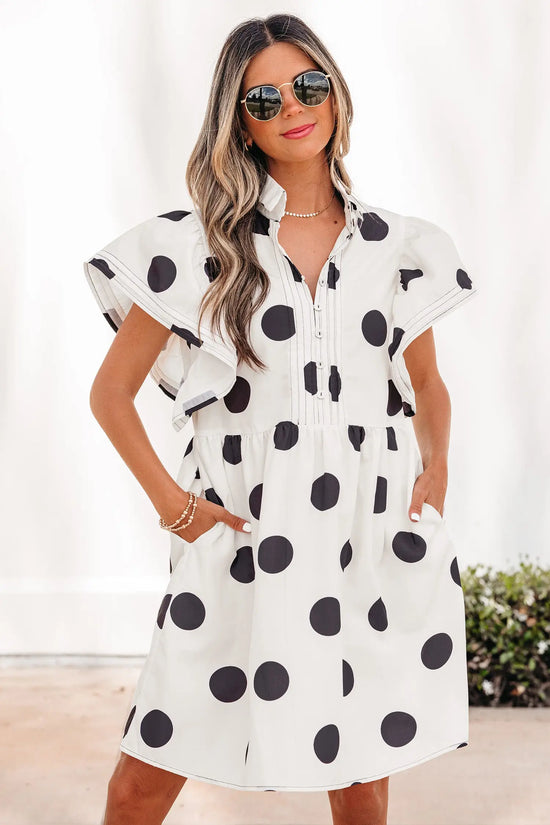 Woman wearing white polka dot high waist A-line mini dress with puff ruffled sleeves, front view, Fashionfitz UK
