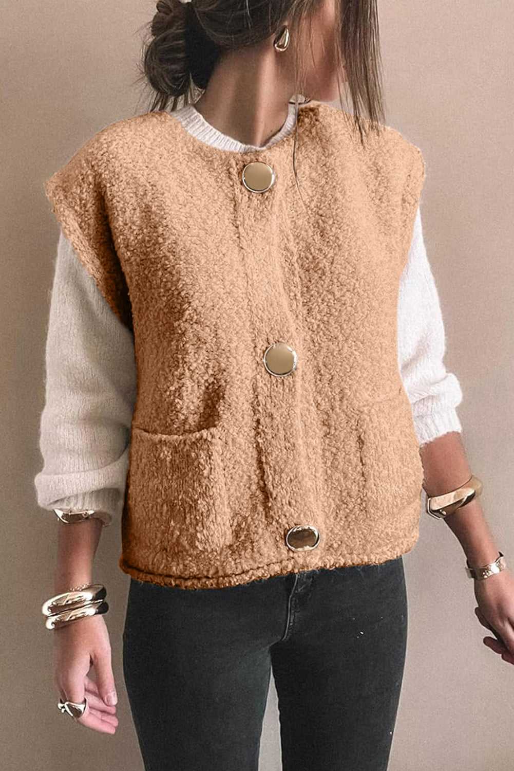 Front view of cozy beige fleece gilet featuring large gold-tone buttons and dual pockets, paired with casual winter wear.