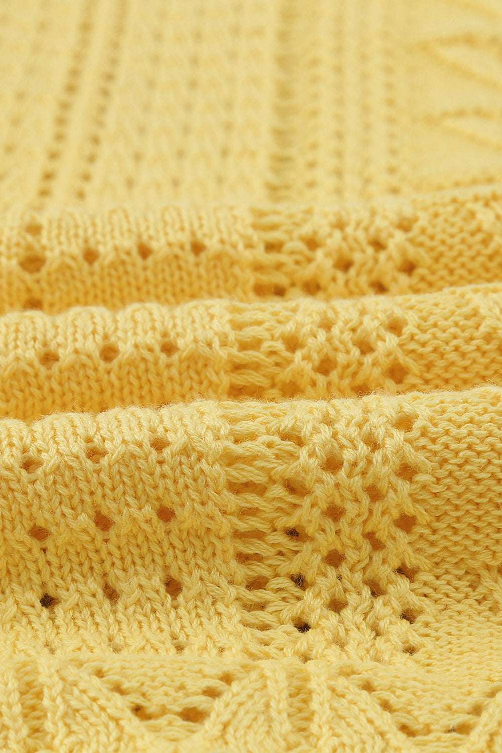 Fabric detail of Yellow Crochet Lace Pointelle Knit Sweater, emphasizing breathable crochet knit ideal for layering in spring.