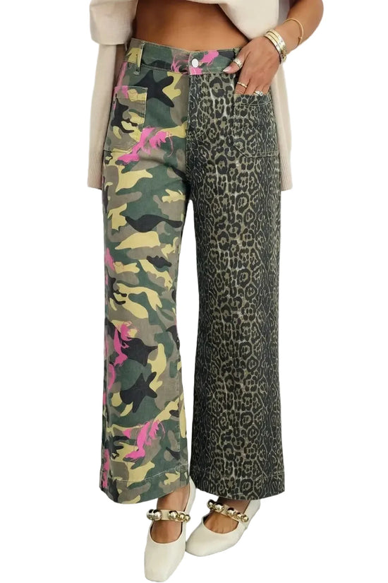 Person wearing camouflage and leopard print pants with a white background