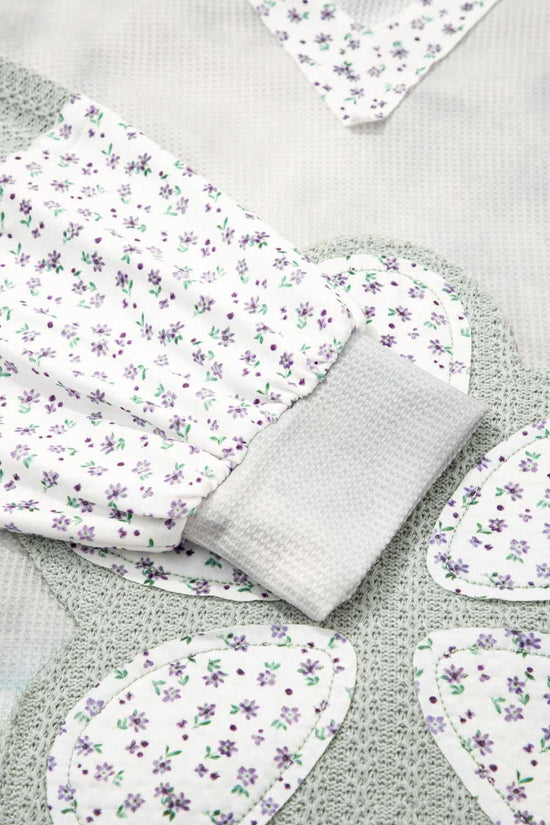 Floral-patterned fabric pieces on a textured surface