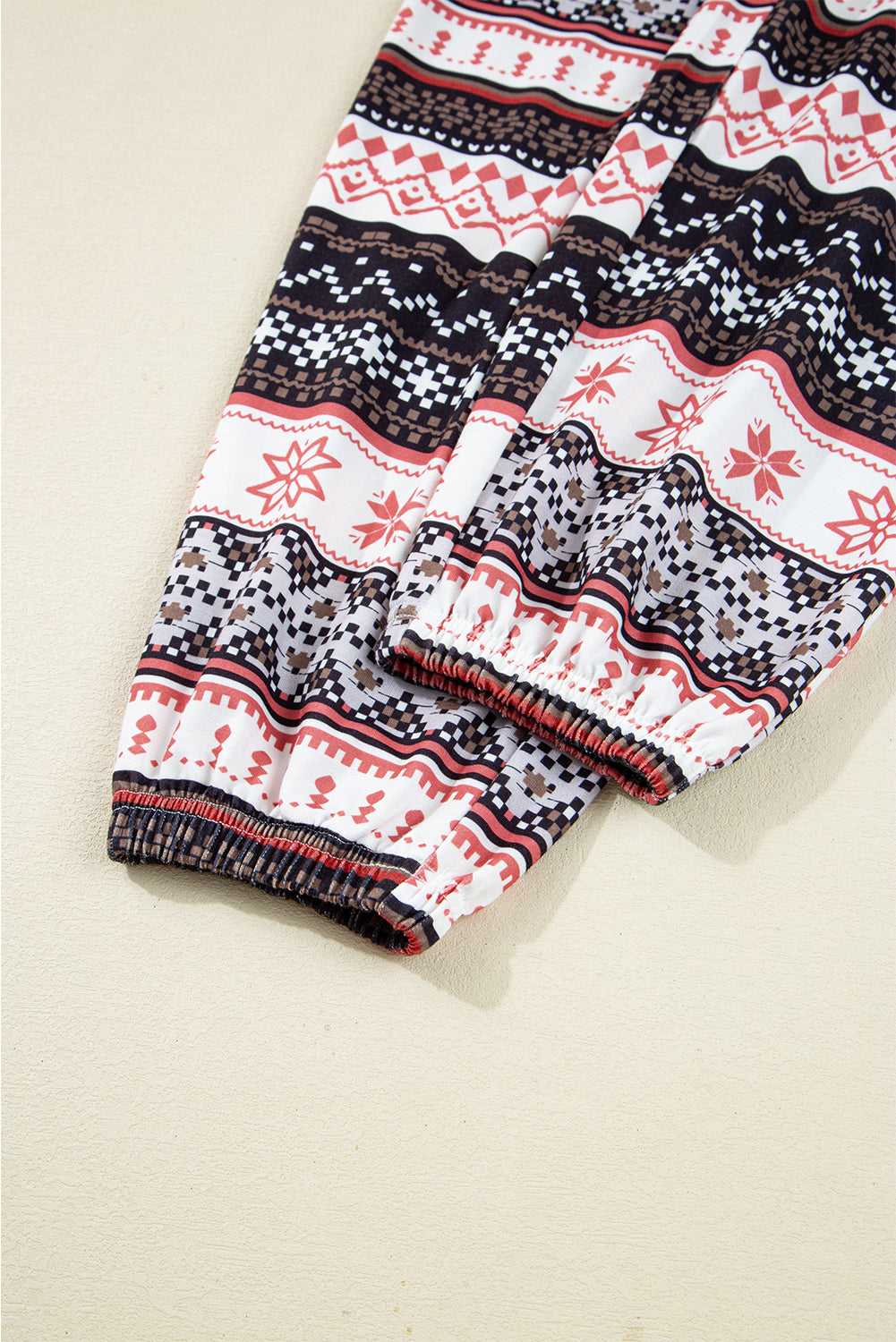 Cuffed pant leg detail of Women's Christmas Comfort Lounge Set in Black by FashionFitz, featuring elastic hem and seasonal print.
