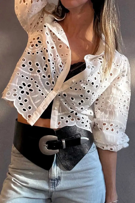 White Cutwork Embroidered Crop Top styled with black belt and light denim jeans, showcasing modern puff sleeve design.